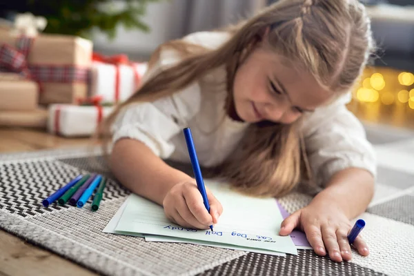 Little Caucasian Girl Lying Carpet Next Christmas Tree Writing Letter — ストック写真