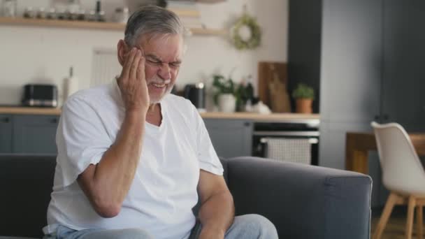 Senior Kaukasische Man Met Hoofdpijn Zittend Bank Thuis Opgenomen Met — Stockvideo