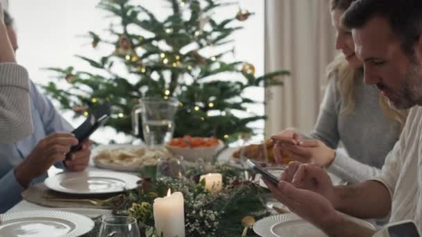 白人の家族はクリスマス イブを携帯電話で過ごしている 8Kでレッドヘリウムカメラで撮影 — ストック動画