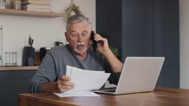 Shocked Caucasian Senior Man Looking Laptop Having Phone Call Shot — Stock Video