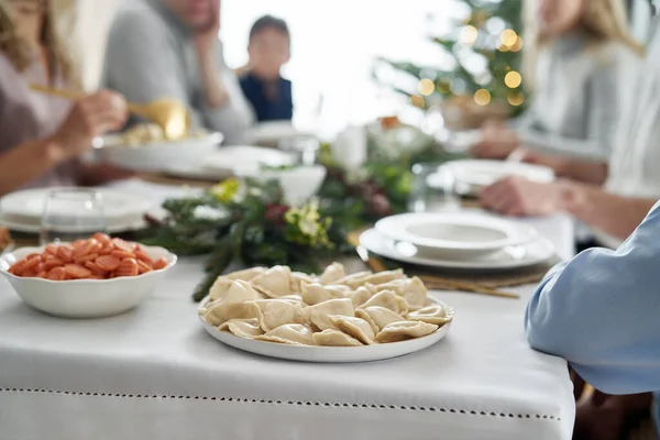 背景にクリスマス イブを祝う餃子と家族でいっぱいのプレート — ストック写真