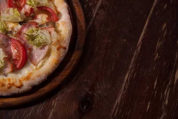 Top view cropped close up of delicious fresh pizza served on cafe table, copy space