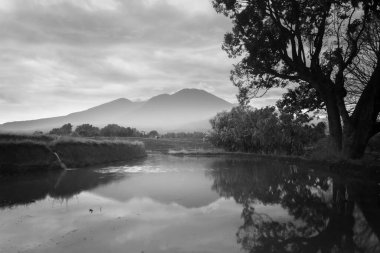Beautiful morning view in Indonesia. Mountain panorama on the water