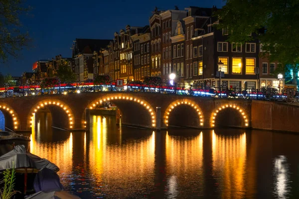 Países Bajos Canal Iluminado Por Noche Amsterdam Muchas Bicicletas Están Imagen De Stock