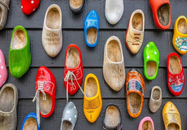 Netherlands. Zaanse Schans. Many different clogs hang on the wall of a wooden house
