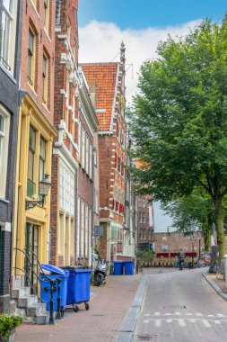 Netherlands. Summer street of Amsterdam. Typical house with a sloping facade among others