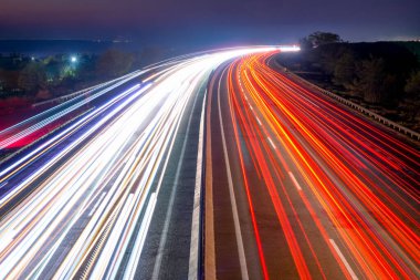 Suburban highway at night. Light plumes from headlights and taillights of heavy traffic in Ukraine before the war