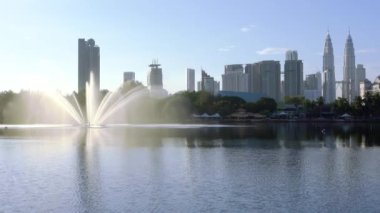 Malaysia. Morning overlooking the lake fountain, skyscrapers and Petronas Twin Towers in Kuala Lumpur