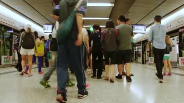 China, Hong Kong - May 1, 2016: Underground part of the subway station. Many passengers leave the wagons and climb the moving staircase