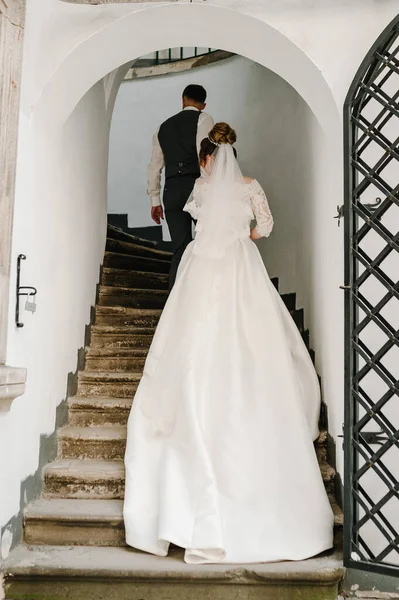 Groom Holds Hand Bride Old Stairs Church Back View — Stock Photo, Image