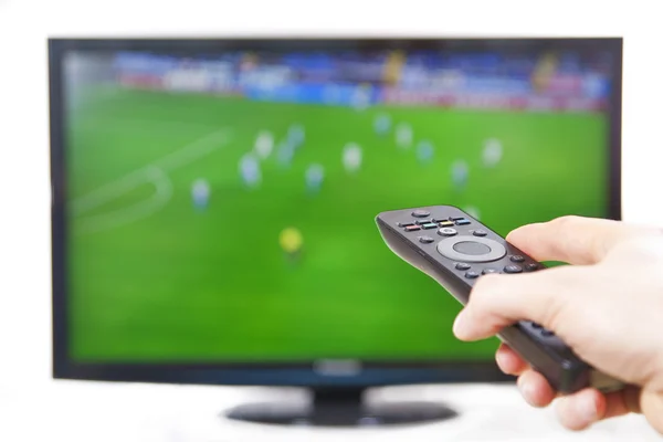 Hombre usando TV Remote Controller viendo deportes — Foto de Stock