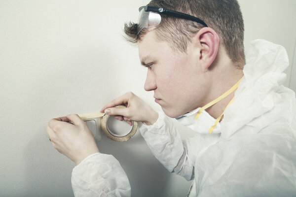 Painter preparing wall to be painted