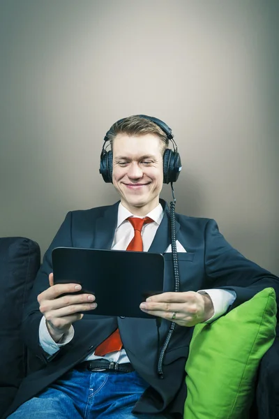 Business man watching movie on tablet