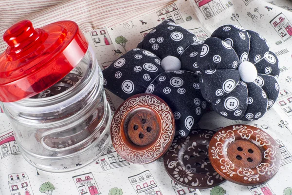 Glass Jar, Neddle Case and Buttons on Fabric. — Stock Photo, Image