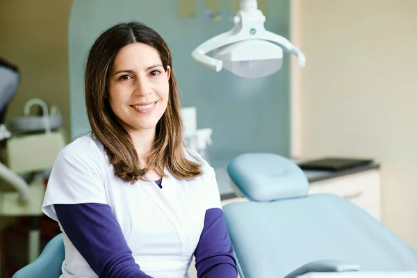 Portrait of a smiling dentist inside the clinic