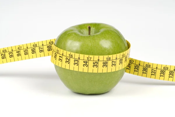 Green apple and tape measure — Stock Photo, Image