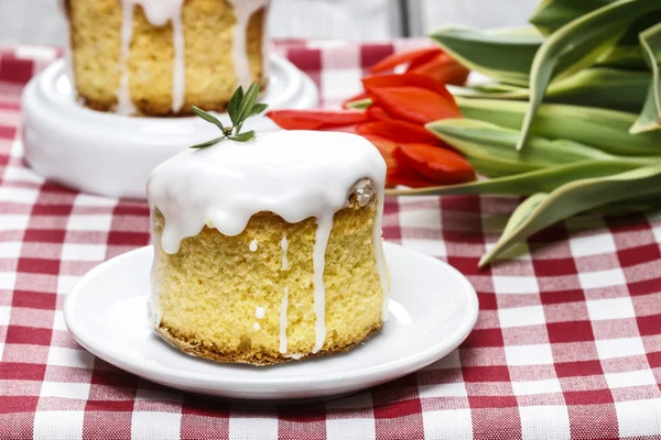 Glazed easter cake on squared table cloth — Stock Photo, Image