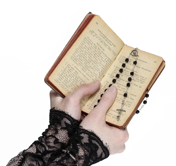 Hands holding the Bible and praying with a rosary — Stockfoto