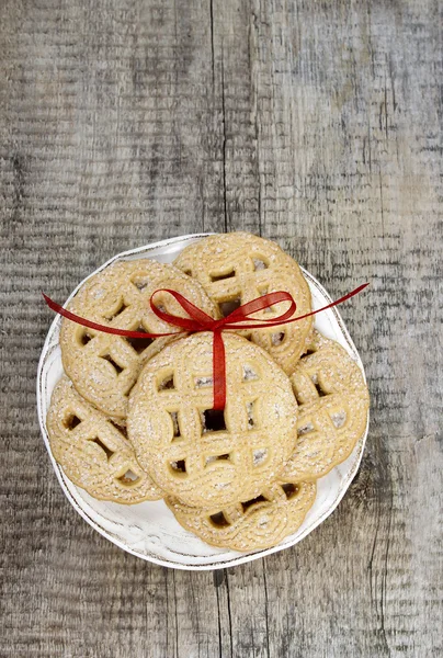 Top view of cookies with red bow on wooden table. — Stock Photo, Image