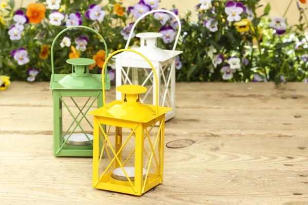 Beautiful colorful lanterns on wooden table at summer party. — Stock Photo, Image