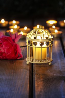 Oriental lantern on wooden table in the evening. Selective focus