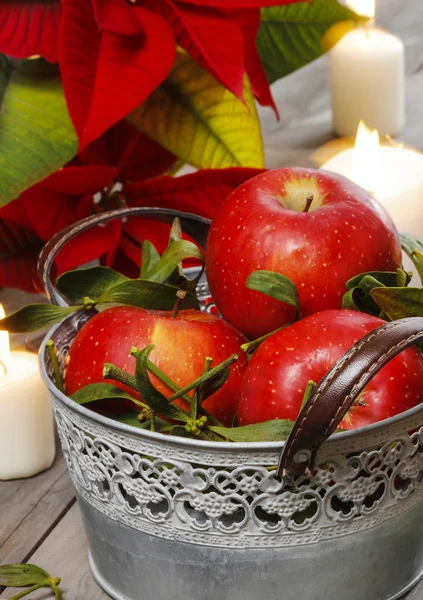 Balde de prata de maçãs maduras vermelhas entre velas — Fotografia de Stock