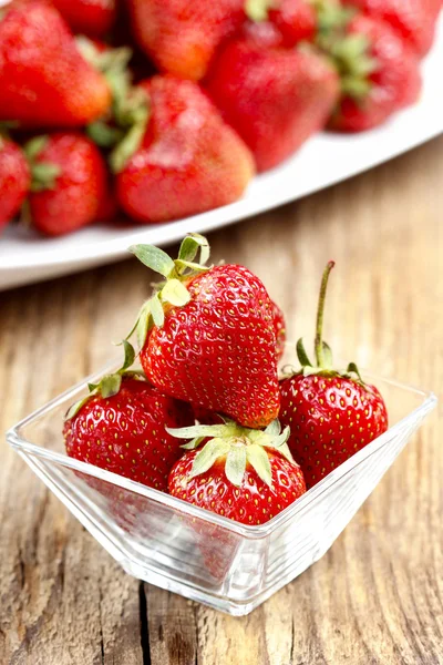 Fresh ripe strawberries in glass bowl — Stock Photo, Image