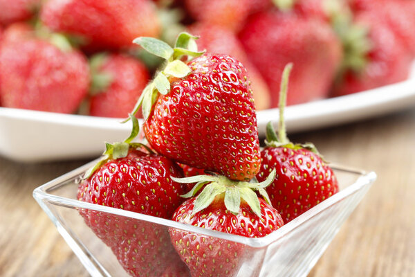 Fresh ripe strawberries in glass bowl