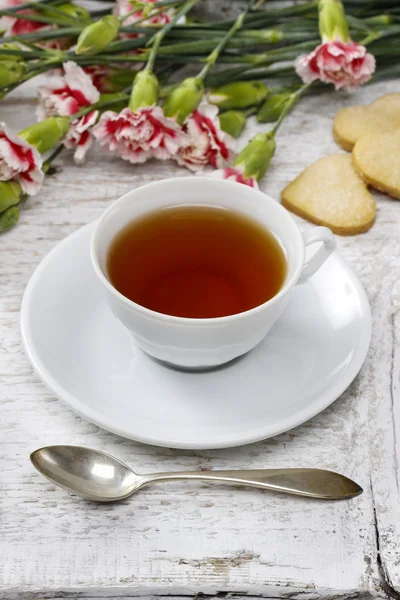 Cup of tea and small cakes on wooden rustic table — Stock Photo, Image