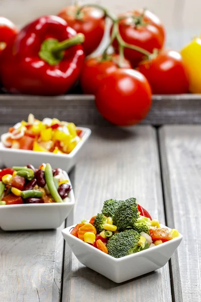 Fresh vegetable salad in white bowl. Spring party table. — Stock Photo, Image