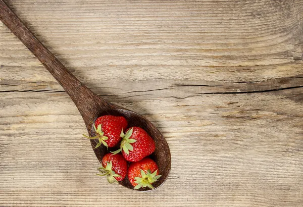 Strawberries on wooden spoon. Copy space. — Stock Photo, Image