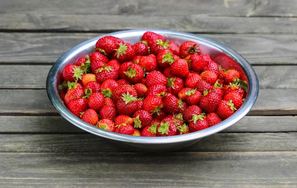 Silver bowl of strawberries on wooden table. Selective focus. — Stock Photo, Image
