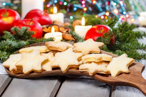 Homemade biscuits in star shape on wooden table in christmas eve — Stock Photo, Image