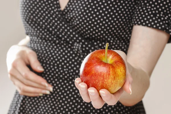 Young girl holding an apple — Stock Photo, Image