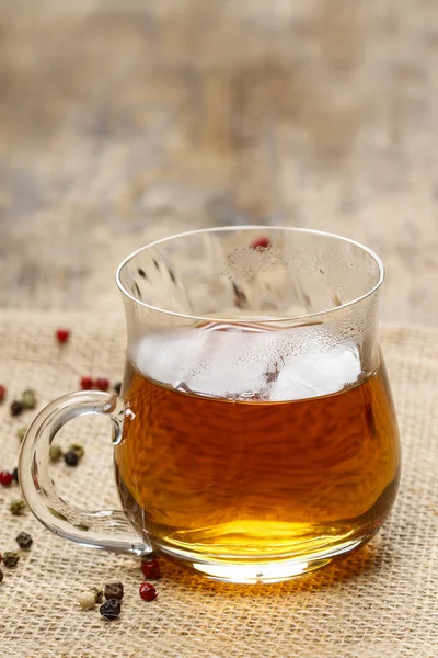 Glass of hot steaming tea on wooden table — Stock Photo, Image