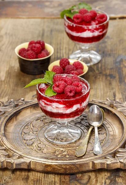 Raspberry dessert on wooden table — Stock Photo, Image