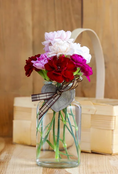 Buquê de flores de cravo rosa, vermelho e branco em vaso de vidro . — Fotografia de Stock