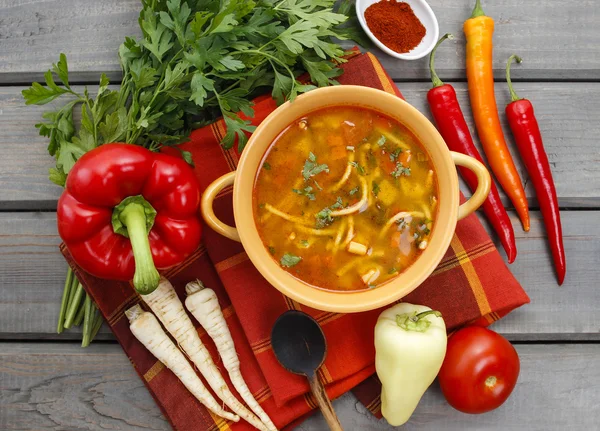 Top view on pot of tomato soup and fresh vegetables on old wood — Stock Photo, Image