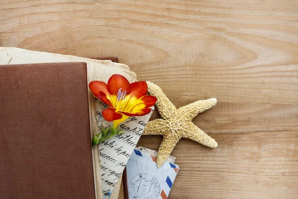 Diary, old letters and red freesia flower on wooden table — Stock Photo, Image