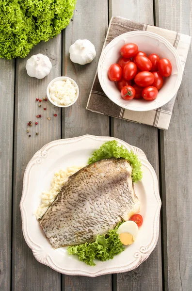 Fried cod on white plate with fresh vegetables and egg — Stock Photo, Image