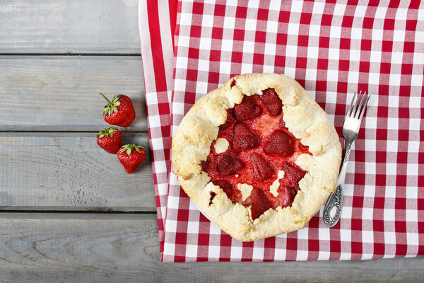 Top view of strawberry galette. Summer pie filled with fruits