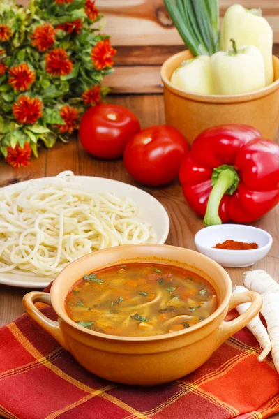 Pot of tomato soup and fresh vegetables on old wooden table — Stock Photo, Image