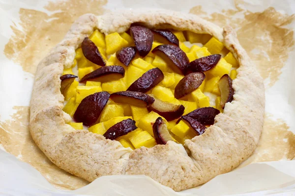 Pumpkin, plum and apricot galette on wooden table — Stock Photo, Image