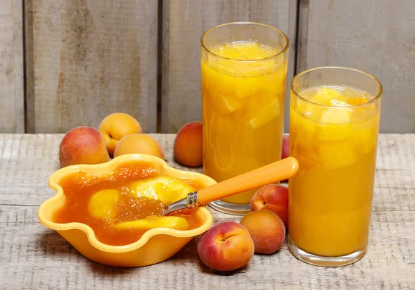 Orange juice and jelly dessert with apricots on wooden table — Stock Photo, Image