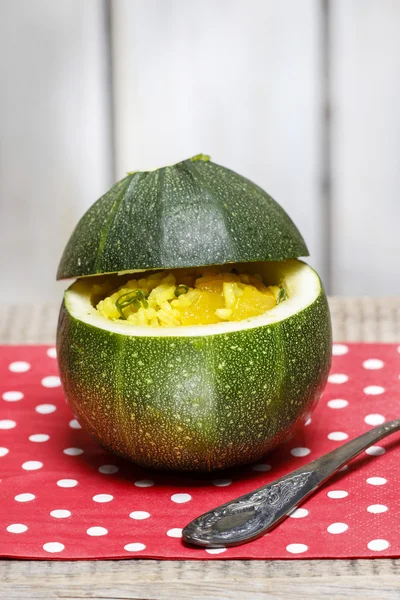 Zucchini stuffed with rice vegetable salad on wooden background. — Stockfoto