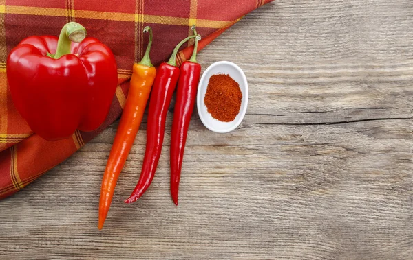 Peppers on old wooden table. Copy space — Stock Photo, Image