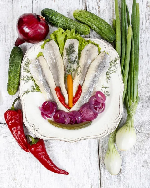 Верхний вид маринованной сельди с овощами на белой деревянной спине — стоковое фото