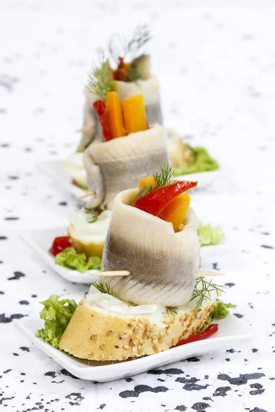 Pickled herring rolls with vegetables — Stock Photo, Image