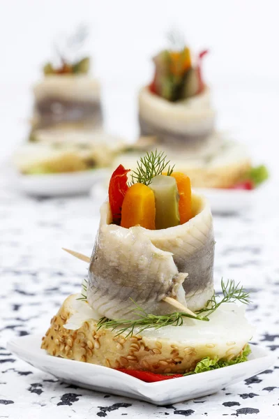 Pickled herring rolls with vegetables — Stock Photo, Image