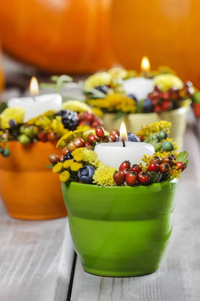 Candle holder decorated with autumn flowers and other plants — Stock Photo, Image